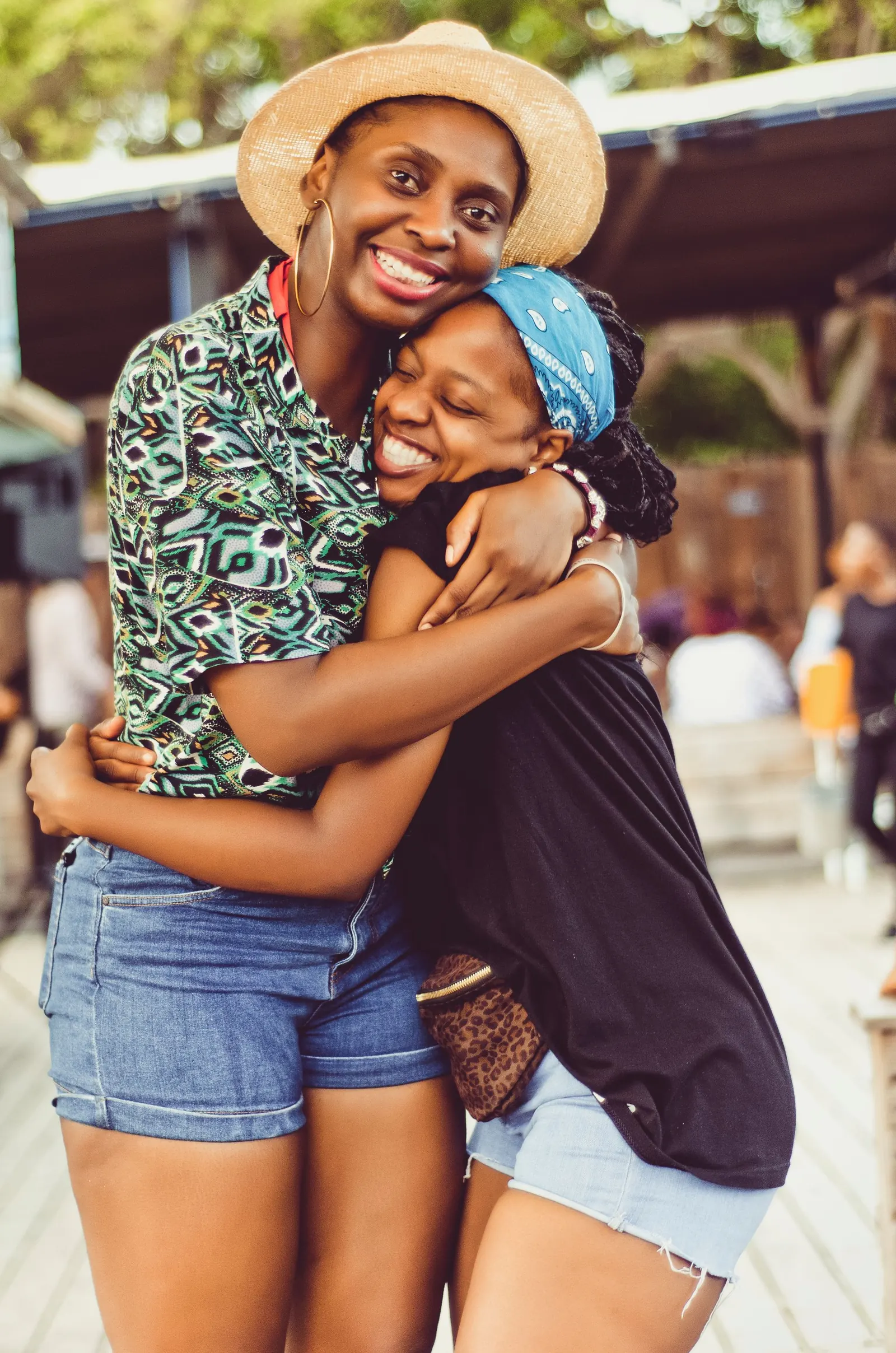 Women standing together, smiling.